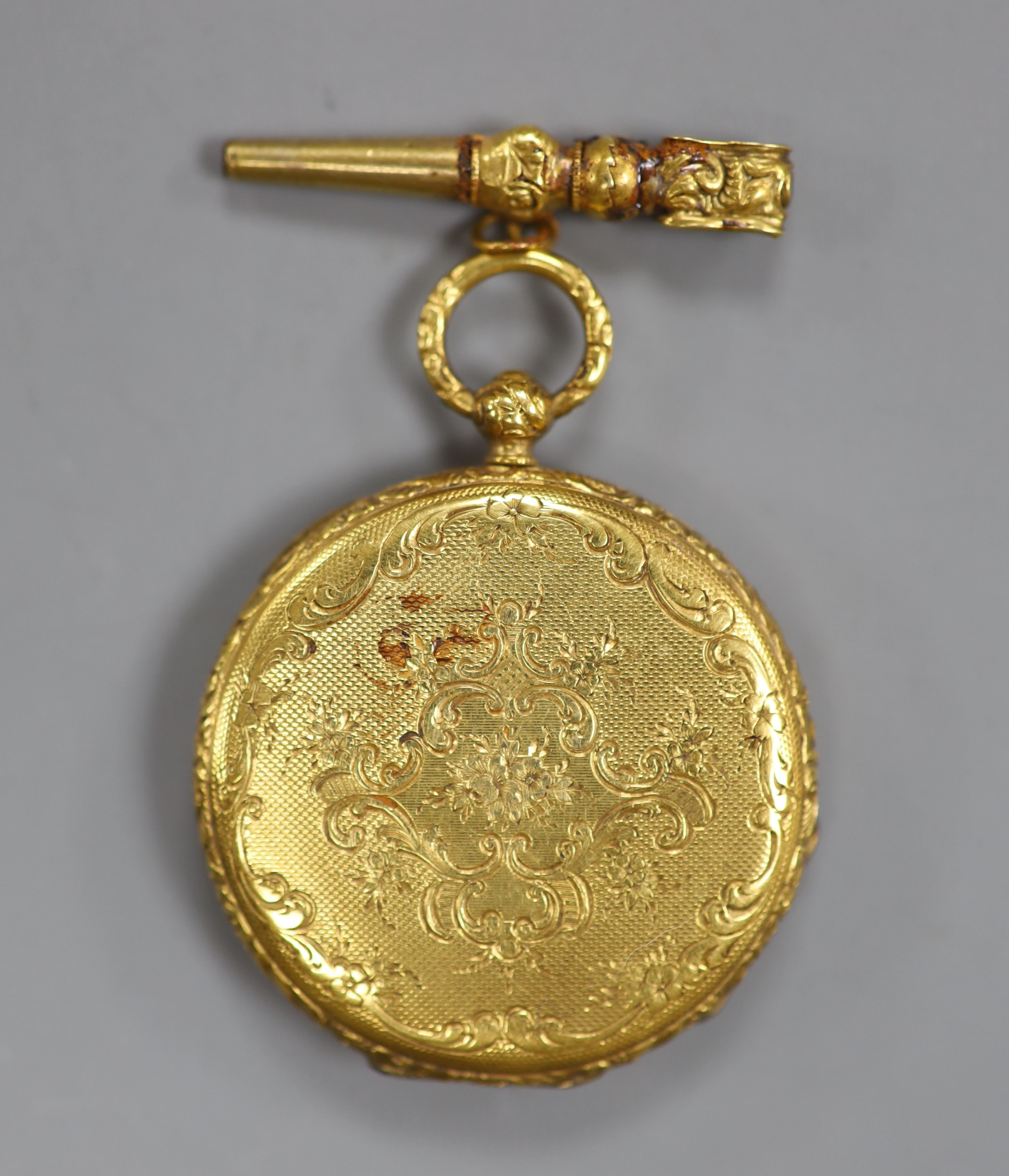 An early 20th century Swiss yellow metal open face fob watch and key, case diameter 27mm, gross 13.7 grams.